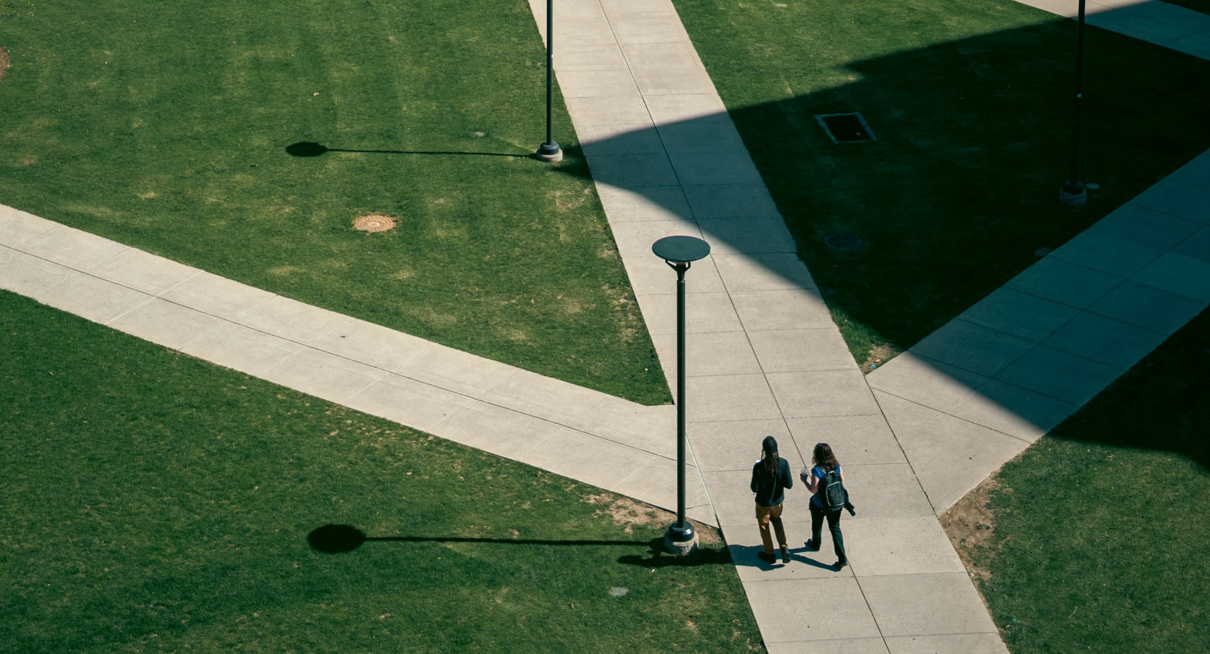 Students walking along the paths of a university campus